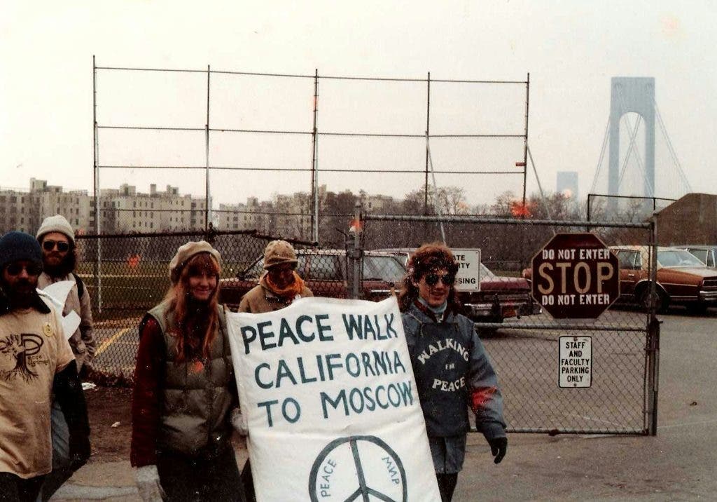 Vintage photo shows people holding up a sign that says "Peace walk California to Moscow"