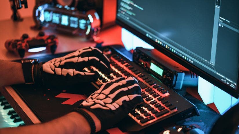 Man uses gaming keyboard with skeleton gloves