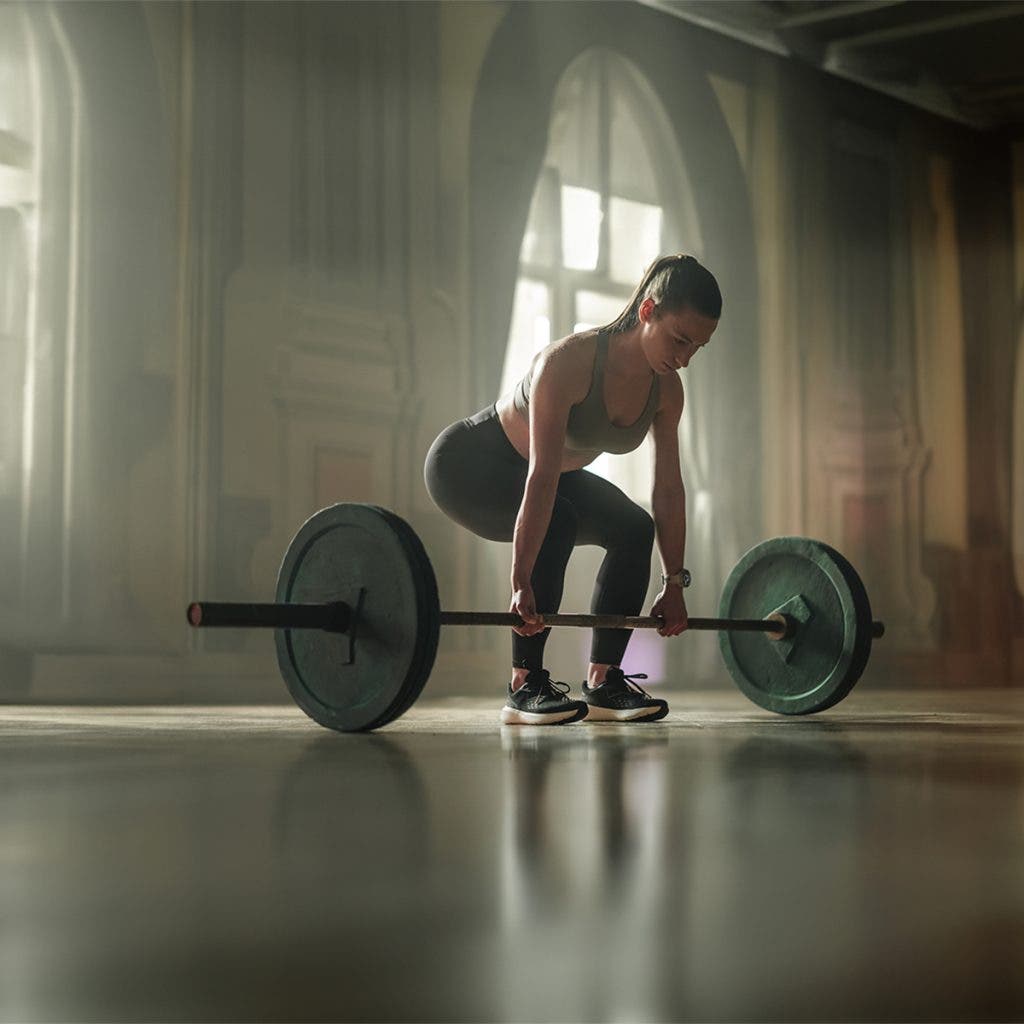 Woman doing strength training works out using the best fitness trackers