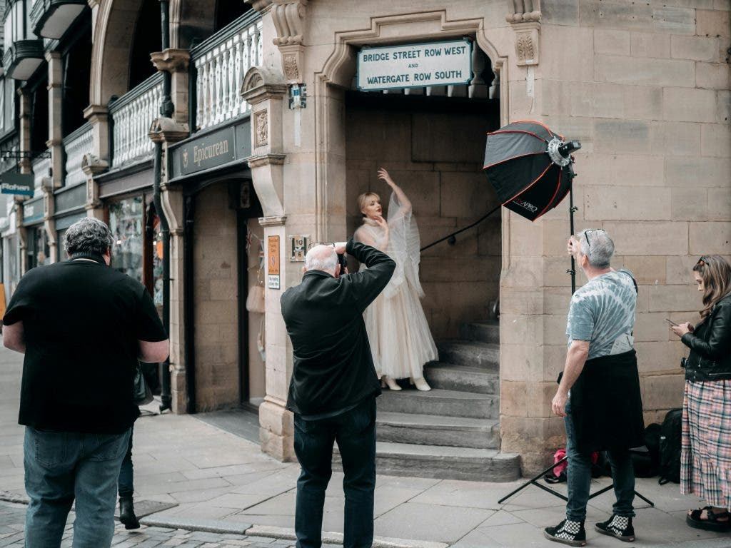 a team of photographers conducting a public photoshoot