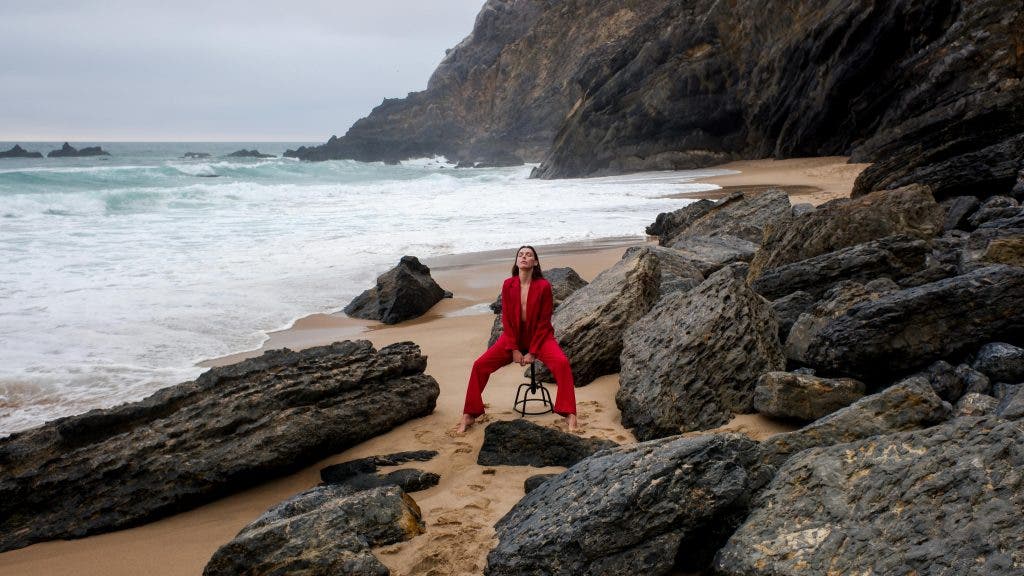 woman on a beach posing for editorial shoot