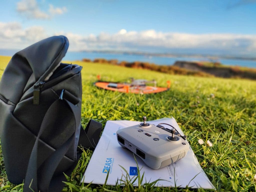 a picture of a drone beside a drone bag