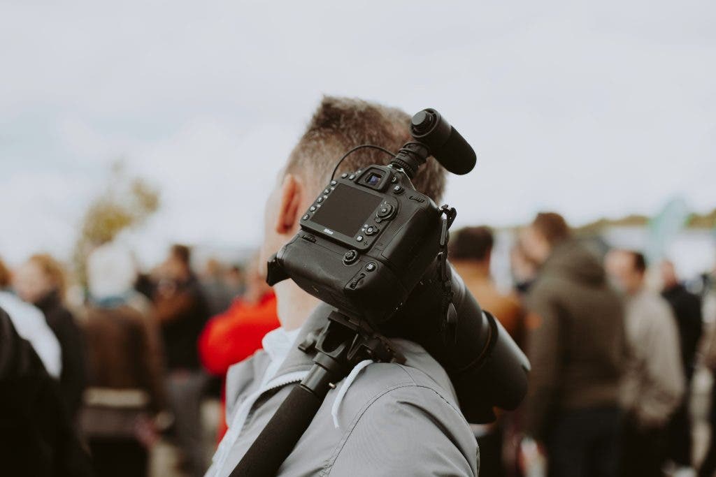 videographer walks around in a festival