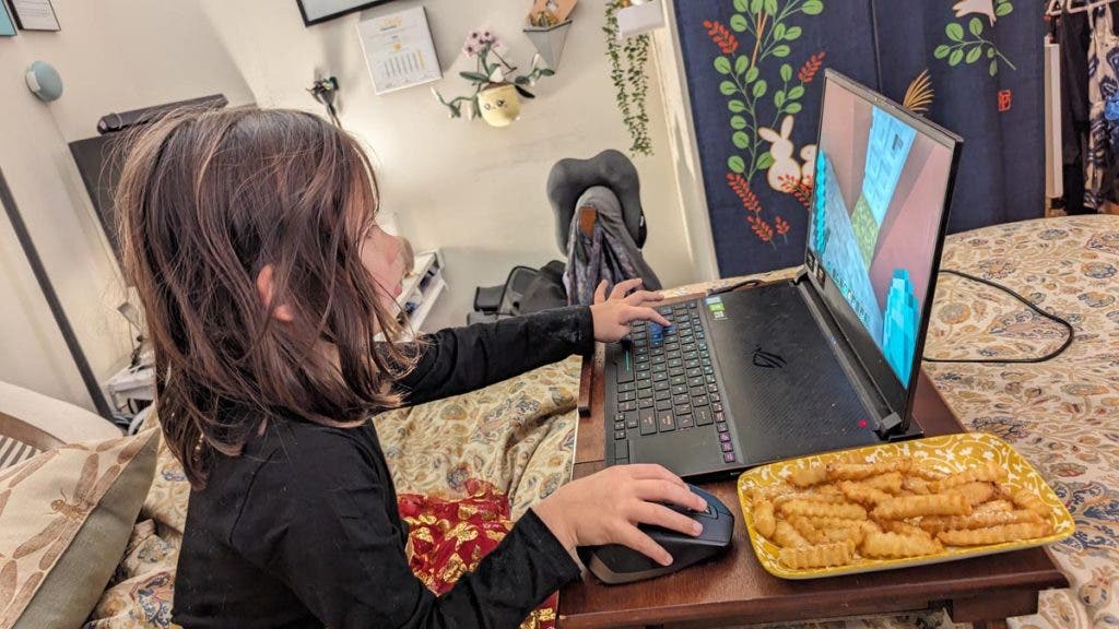 Caption: You can’t properly play Minecraft without being able to read and type. Otherwise, you may end up drowning in a house made of sand.