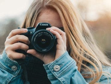 Female Canon EOS photographer looking through her camera