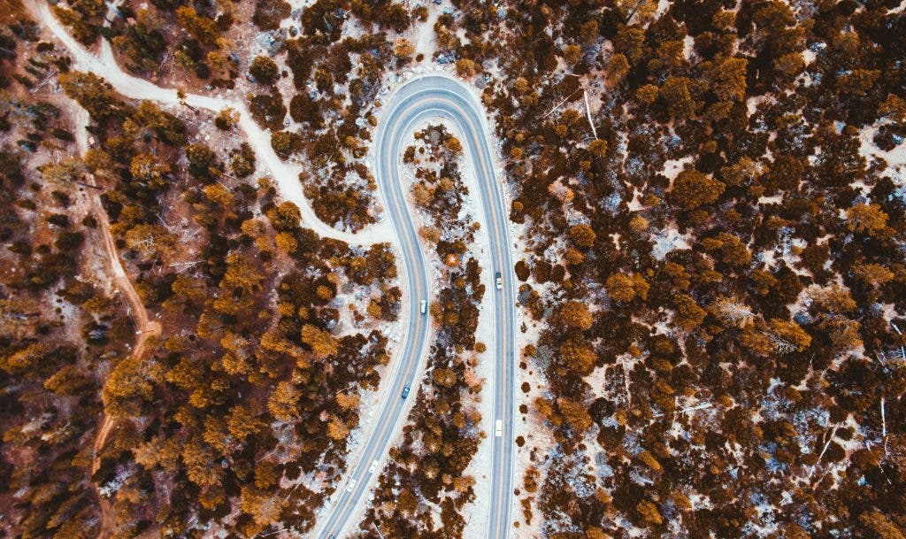 an aerial photo of a highway in autumn
