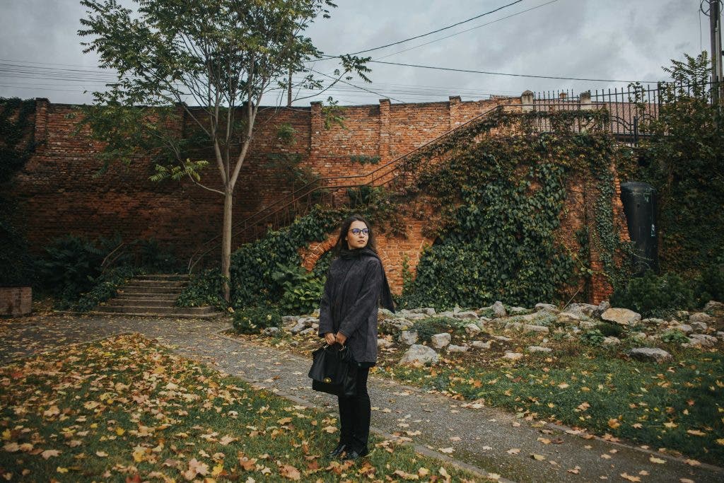 a photo of a woman in the middle of autumn
