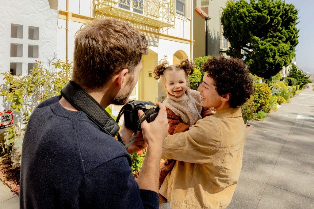 photographer takes a photo of a mom holding a baby