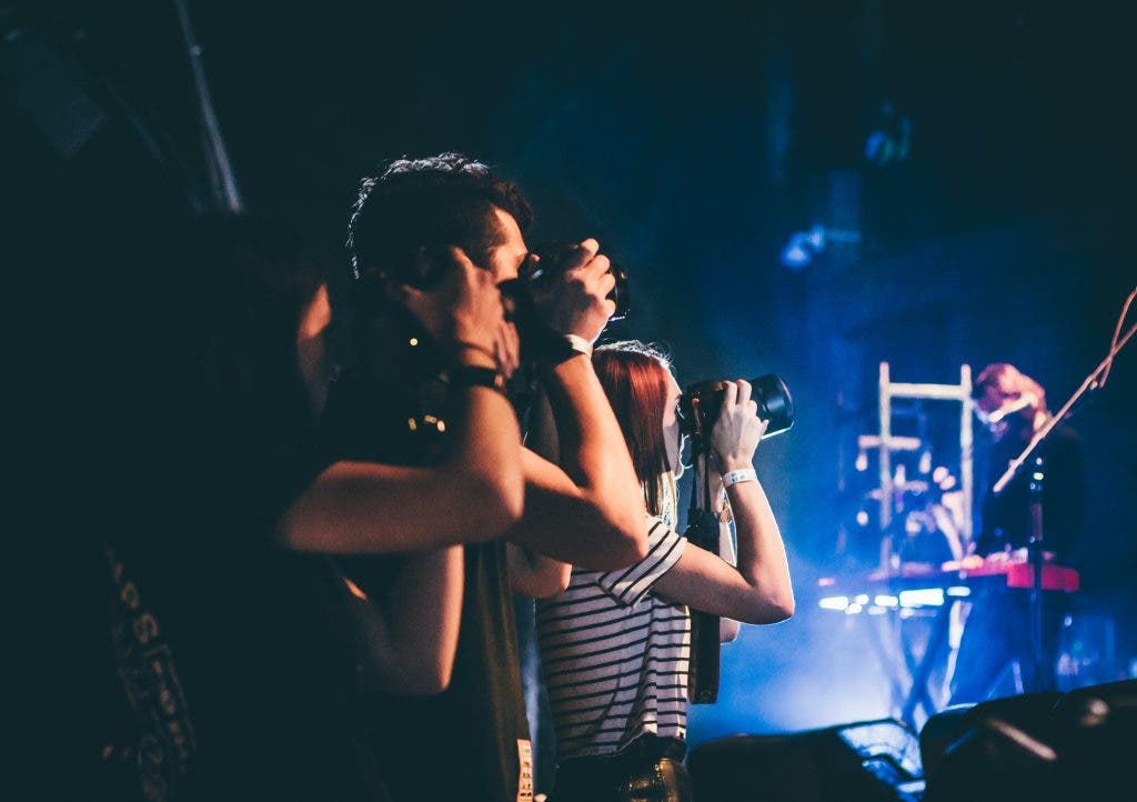 a group of photographers shoot a concert
