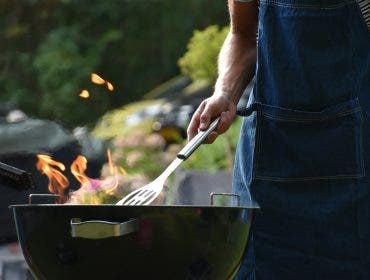 someone cooking in their backyard entertaining setup