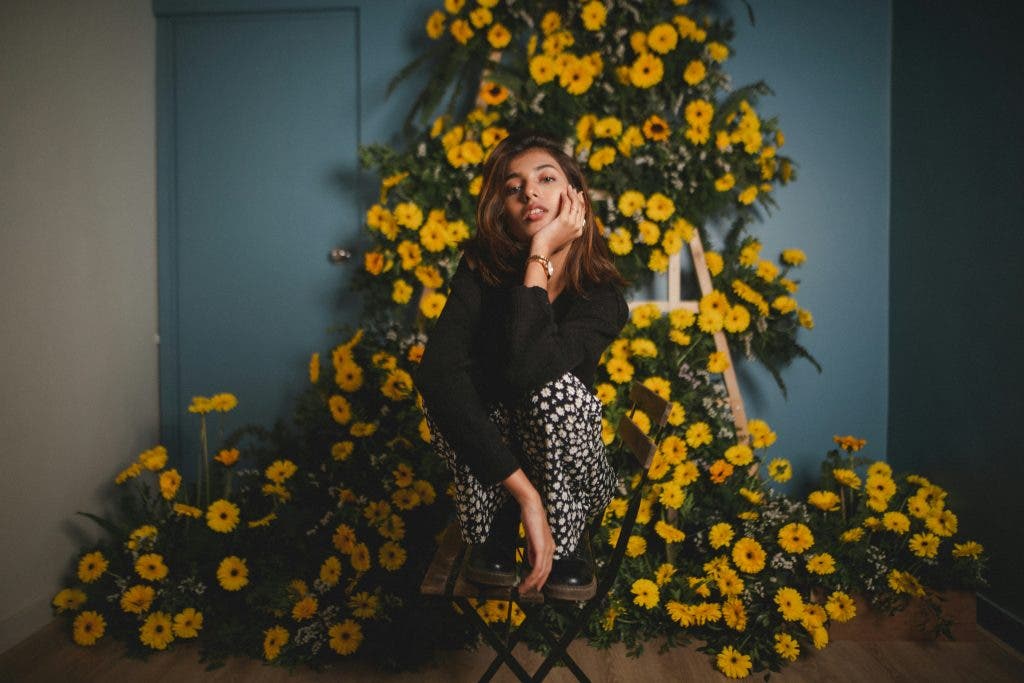 an online model in front of a flower arrangement