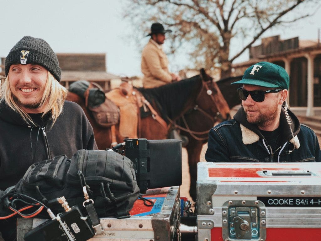 a photo of a filmmaking crew behind the scenes of a movie