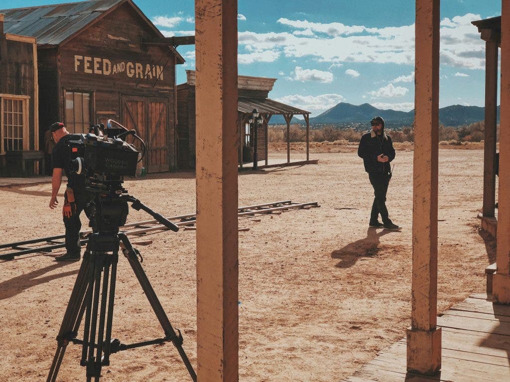 a person talking about how to start filmmaking on set at a western town
