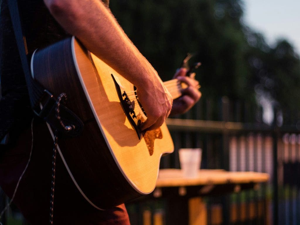 a person showing off their talent with the guitar