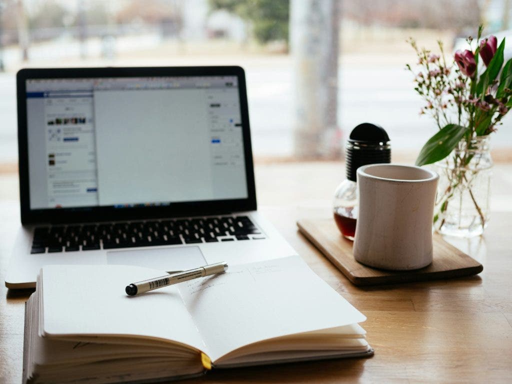 A desk of a digital marketer wondering "How to start content writing from home"