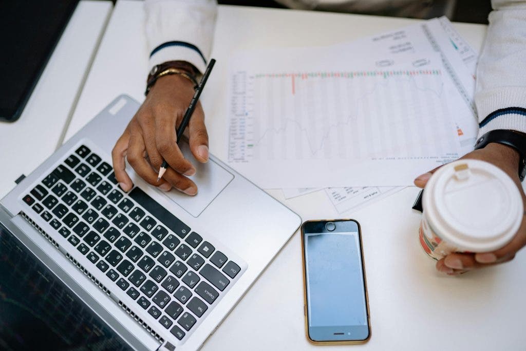 a digital marketing employee with a coffee on their desk