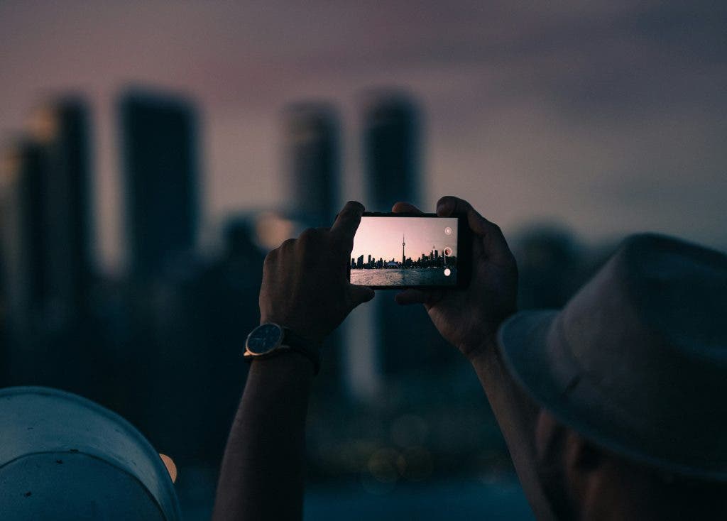 how to film a movie with a smartphone, exhibited by a person in the picture