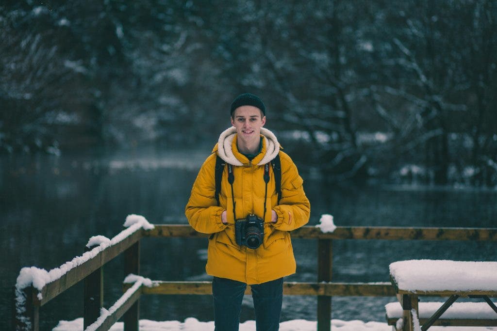 a man doing winter photography who knows about camera protection techniques