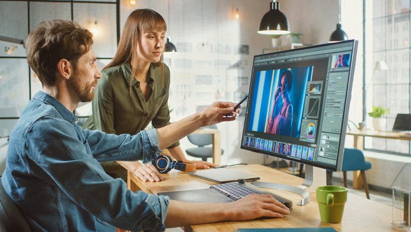 Female Art Director Consults Designer Colleague working on a Portrait using a Photo Editing Software. By Gorodenkoff on Adobe Stock