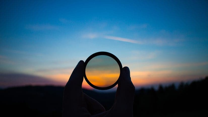 Hand holding filter lens camera, sunset, mountain, landscape