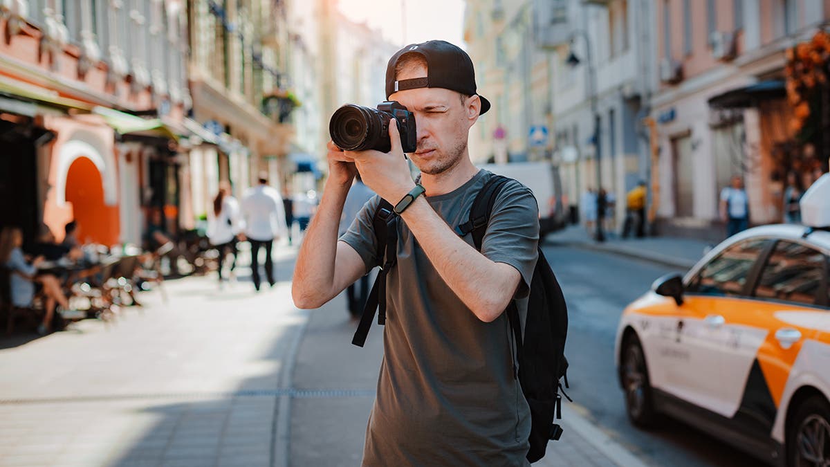 man-taking-photos-on-a-travel-with-his-camera