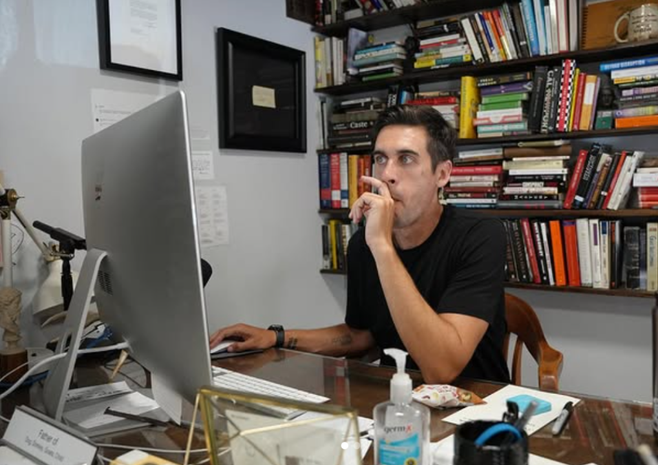 Ryan Holiday sitting on his desk