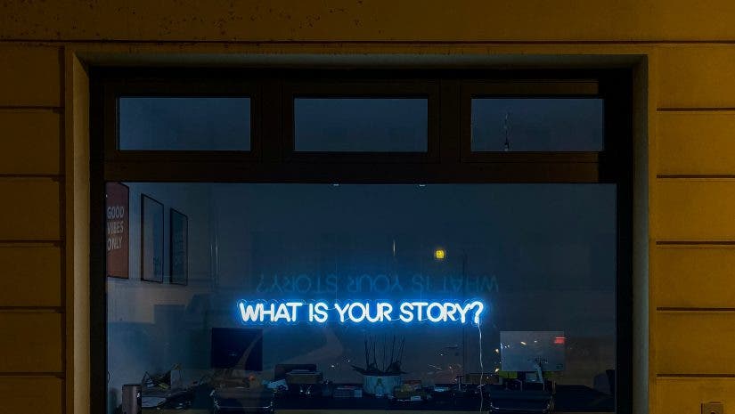 a neon light that says "what is your story?"