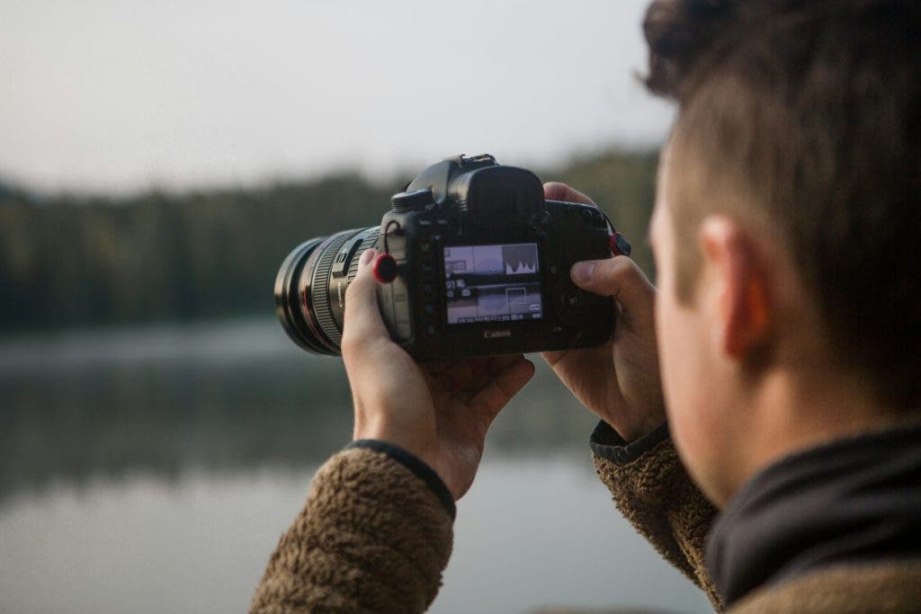 a photographer adjusting camera settings