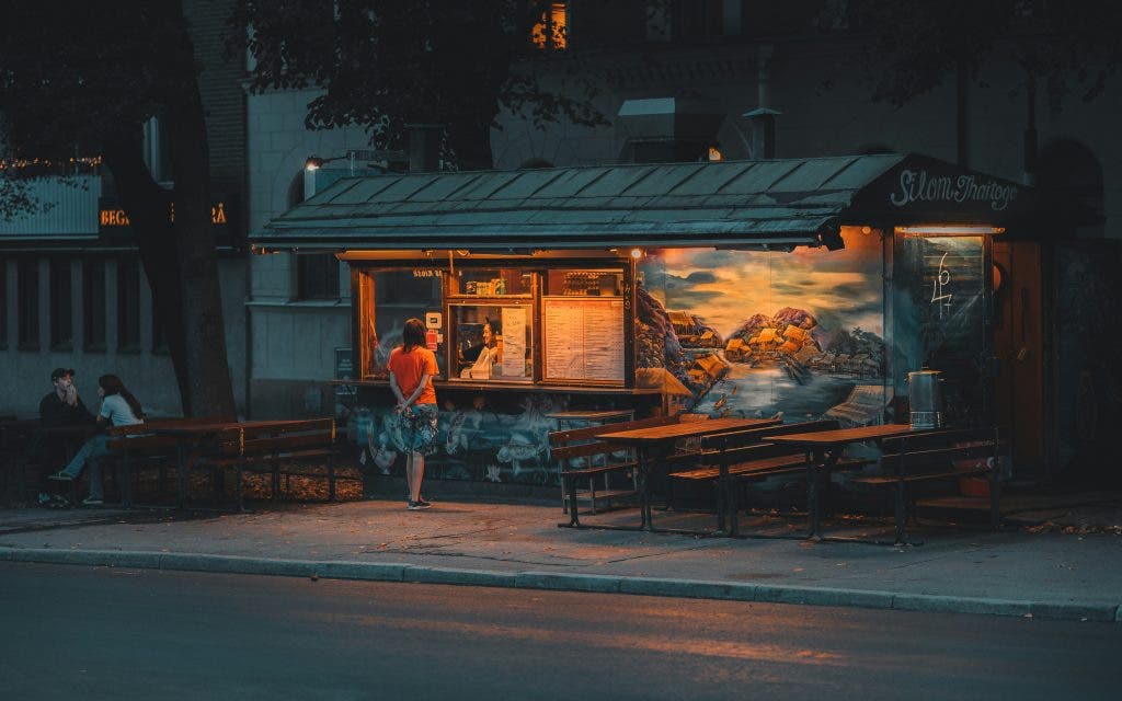 a warm restaurant photographed at night