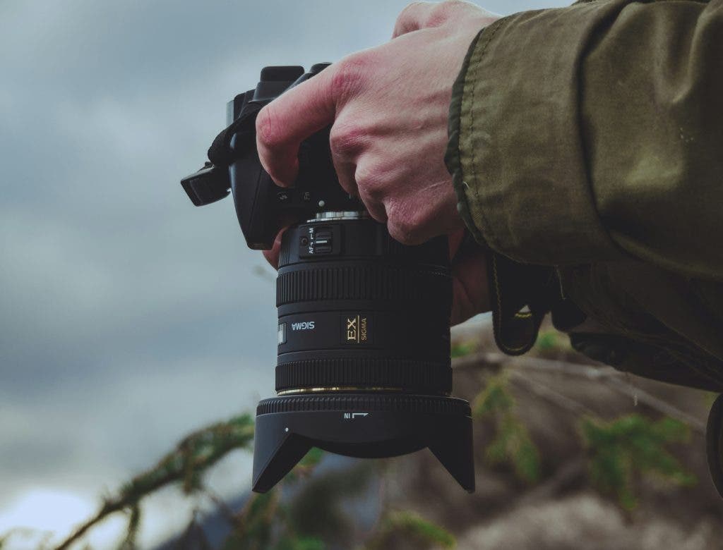 a photographer figuring out how to do camera settings