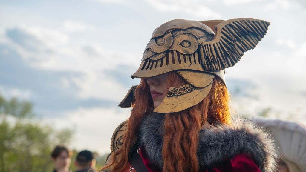 a ginger cosplayer wearing a battle helmet and fur coat