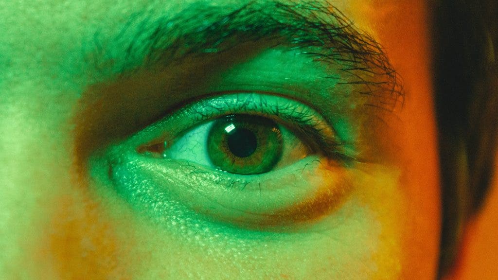 a green light being flashed into a guy's eye