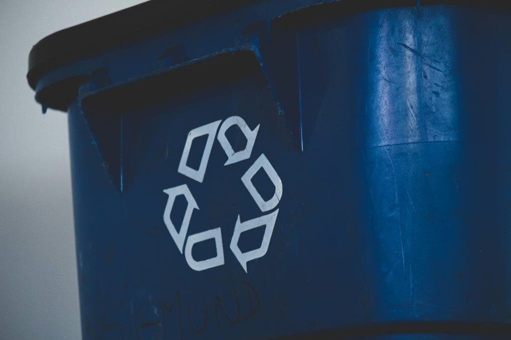 a picture of the reduce reuse recycle sign on a trash bin