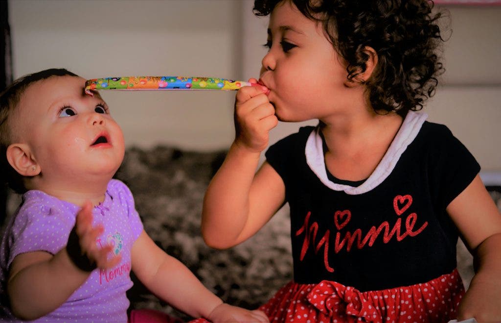 fun newborn photograph with older sibling