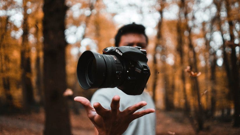 a photographer tossing a DSLR into the air