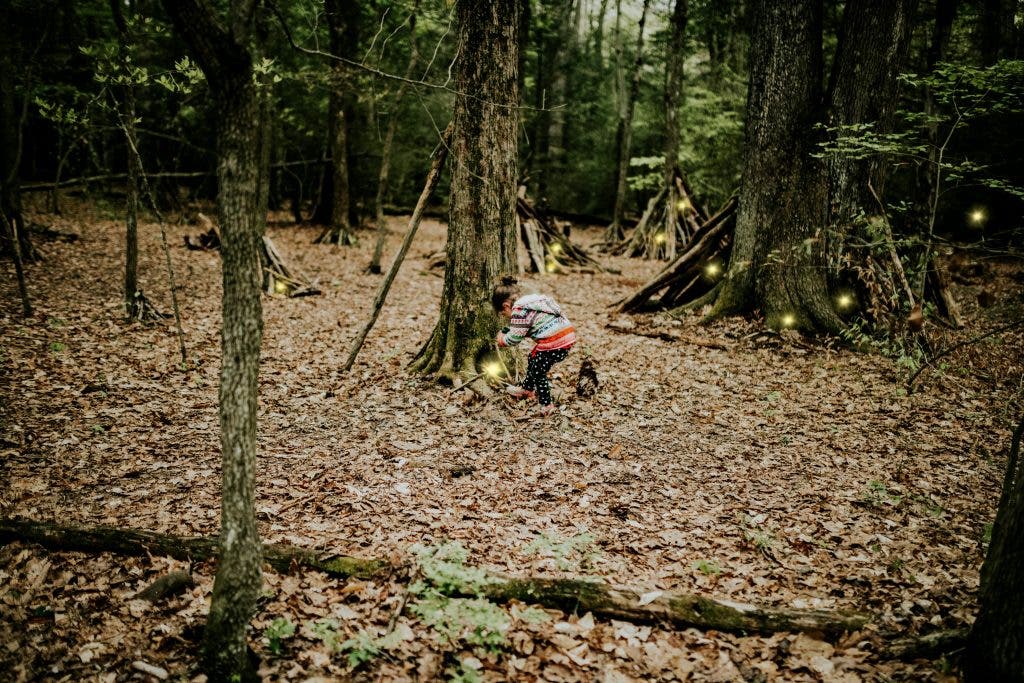 photo of kid going around in the forest on a summer scavenger hunt