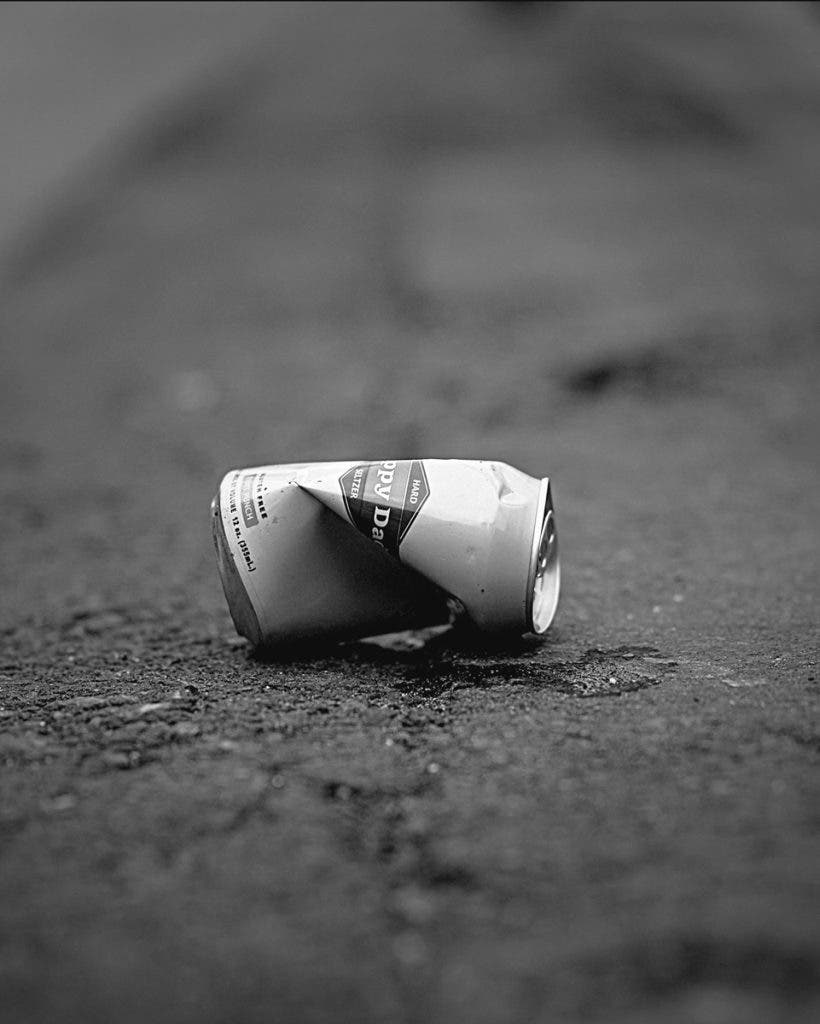 This crushed can isn’t just trash—it’s a reminder that everything, even the discarded, has a shape worth seeing.