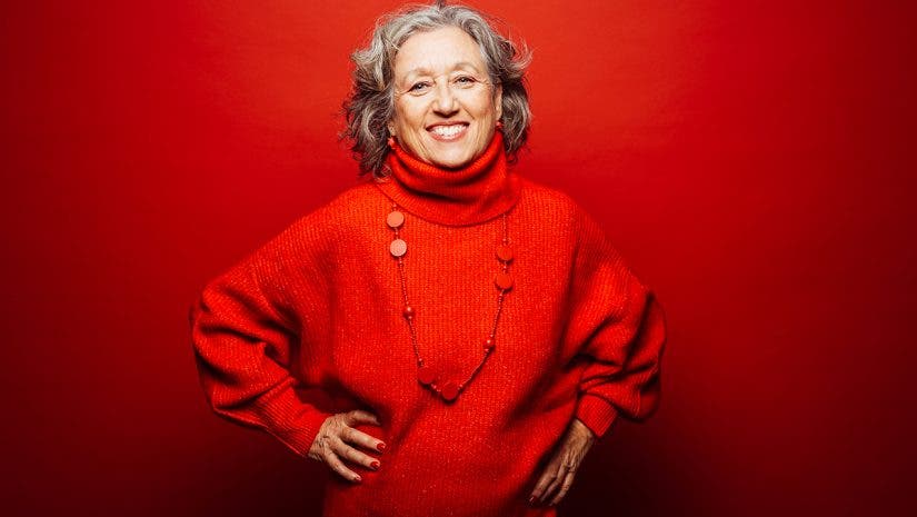 Senior smiling woman red clothes over a red background