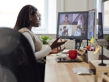 A side view of a manager speaking to her staff who are working from home. She is having a team briefing and getting up to date with everyones progress. She is working in her office in Newcastle Upon Tyne in the North East of England.