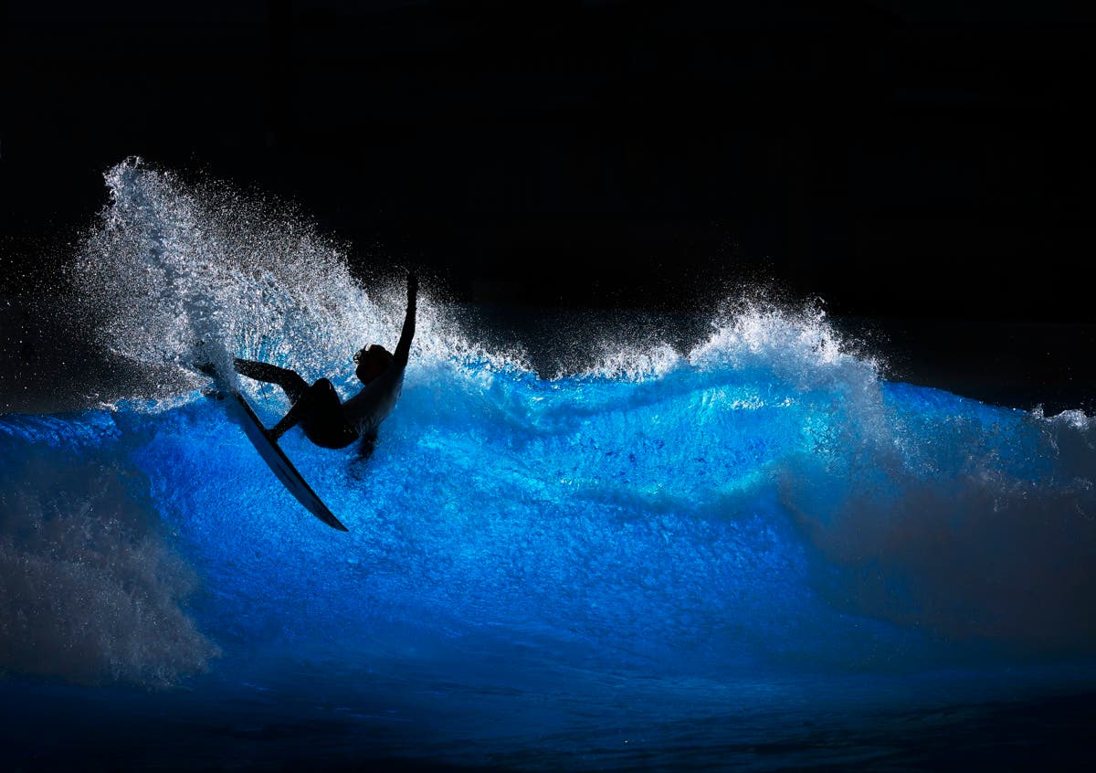 HALLBERGMOOS, GERMANY - OCTOBER 07: Aelan Vaast of French Polynesia performs a layback hack during a private surf training sessio at 02 Surftown MUC on October 07, 2025 in Hallbergmoos, Germany. Seven surfers from France and French Polynesia traveled to Munich for some intensive surf training sessions at Surftown MUC. The wave pool can provide a variety of different waves from a point break or A frame to a fast hollow wave with air sections allowing for a huge variety of surfing conditions. (Photo by Adam Pretty/Getty Images)