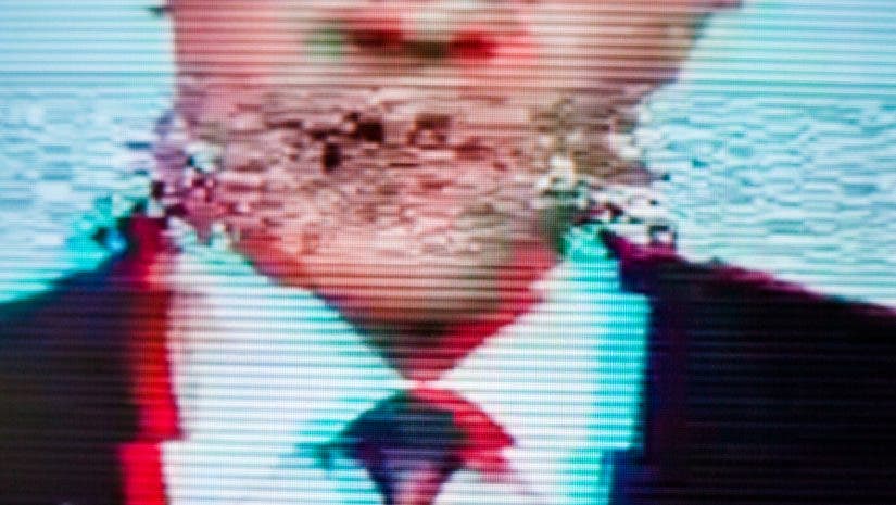 Man in a suit on the screen. Broadcaster. Glitch. Digital errors on the screen.