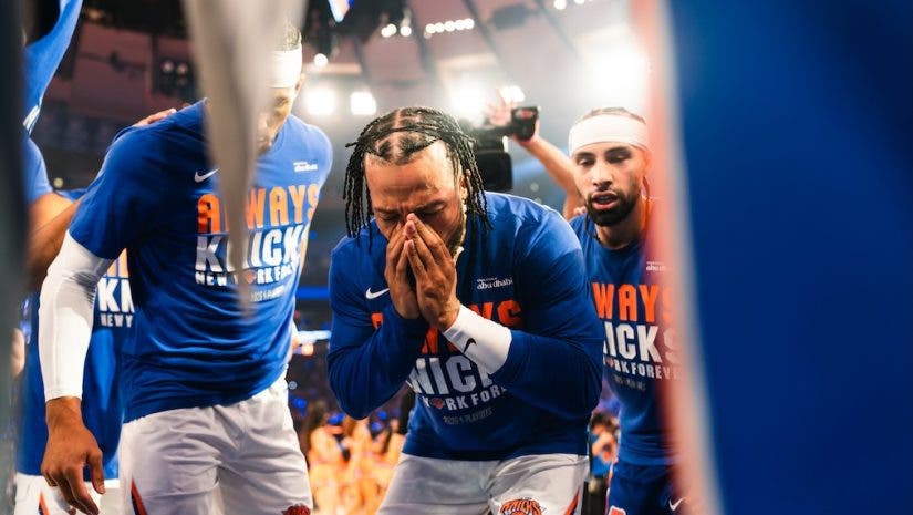 An emotional Jalen Brunson is surrounded by New York Knicks teammates during the playoffs against the Cleveland Cavaliers